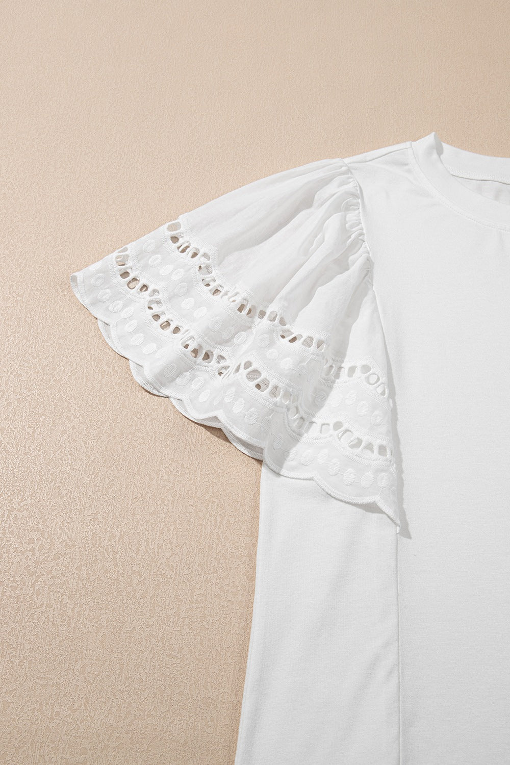 Hollow out embroidered short sleeve round neck top.