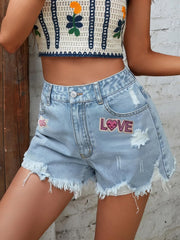 LOVE distressed raw hem denim shorts with buttons and pockets.