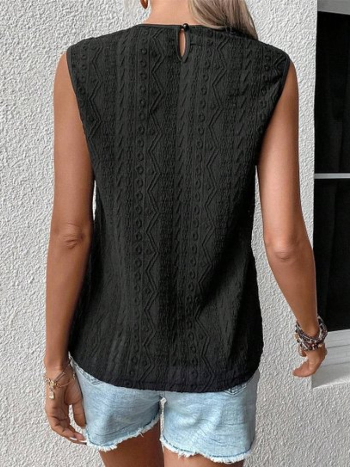 Lace eyelet sleeveless top.
