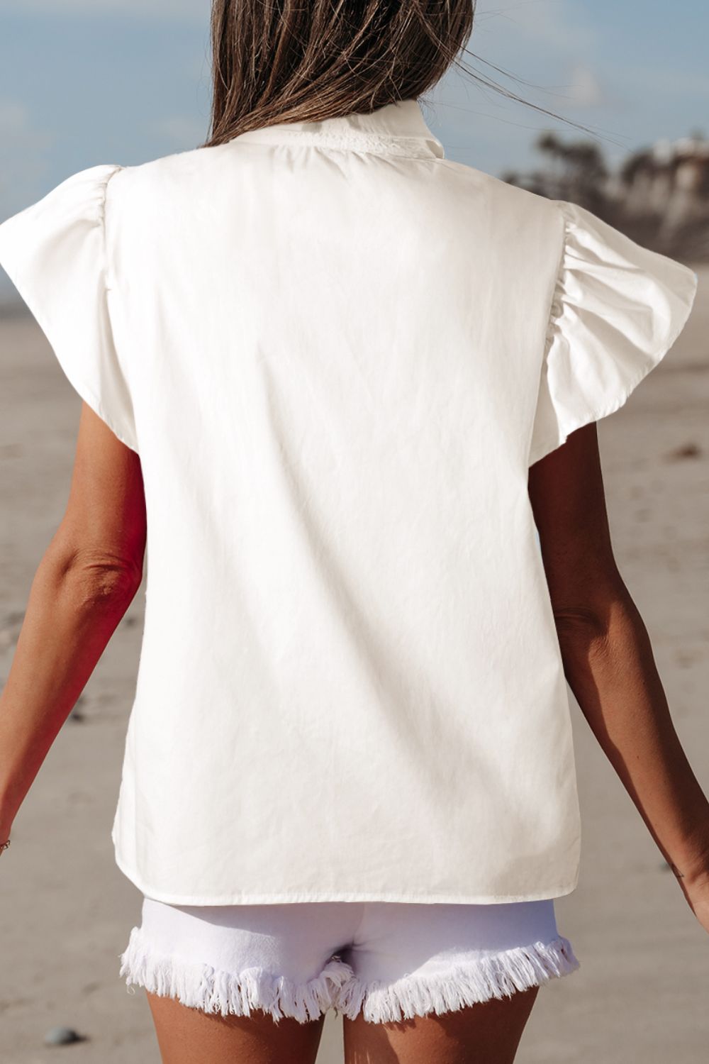 Lace Patchwork Ruffled Cap Sleeve Blouse with Buttoned Details.