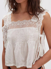Lace-trimmed eyelet square neck top with tie detail.