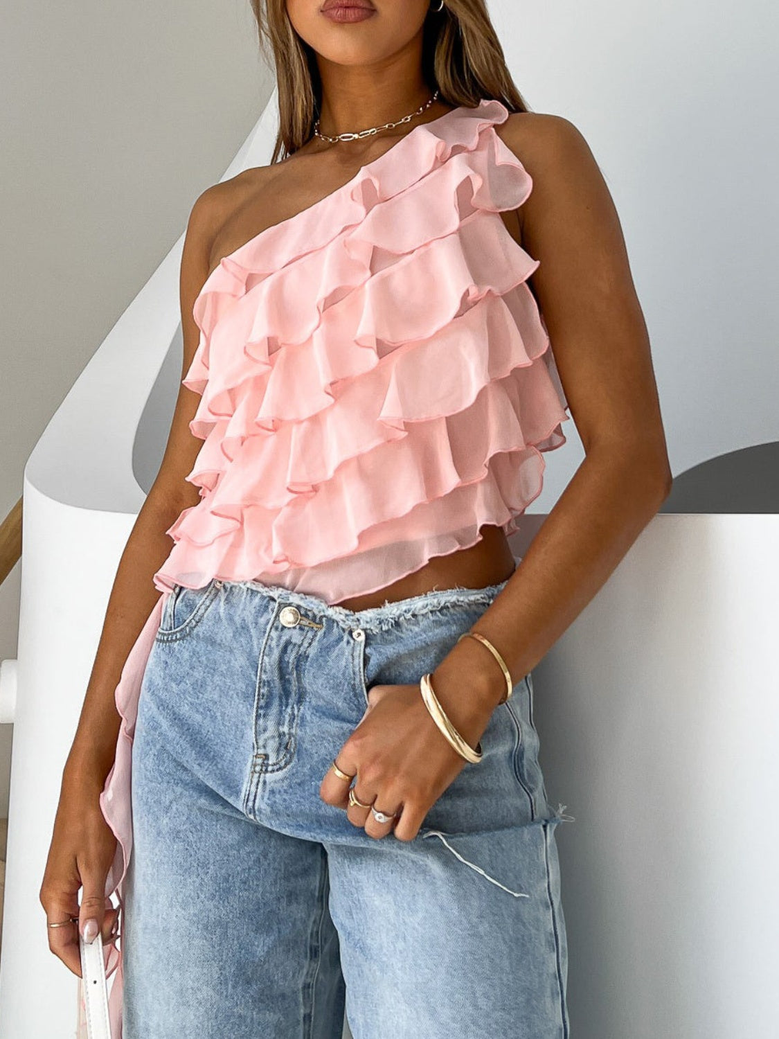 Layered ruffled one-shoulder tank top.