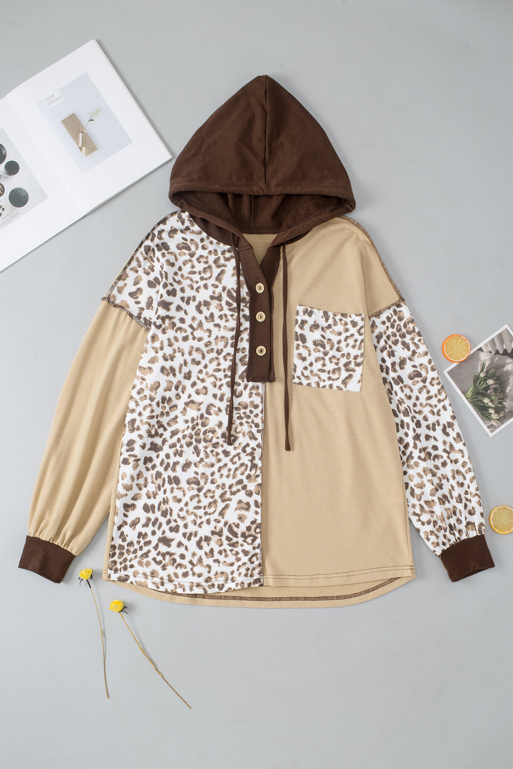 Leopard print drawstring hoodie with a chest pocket and buttons.