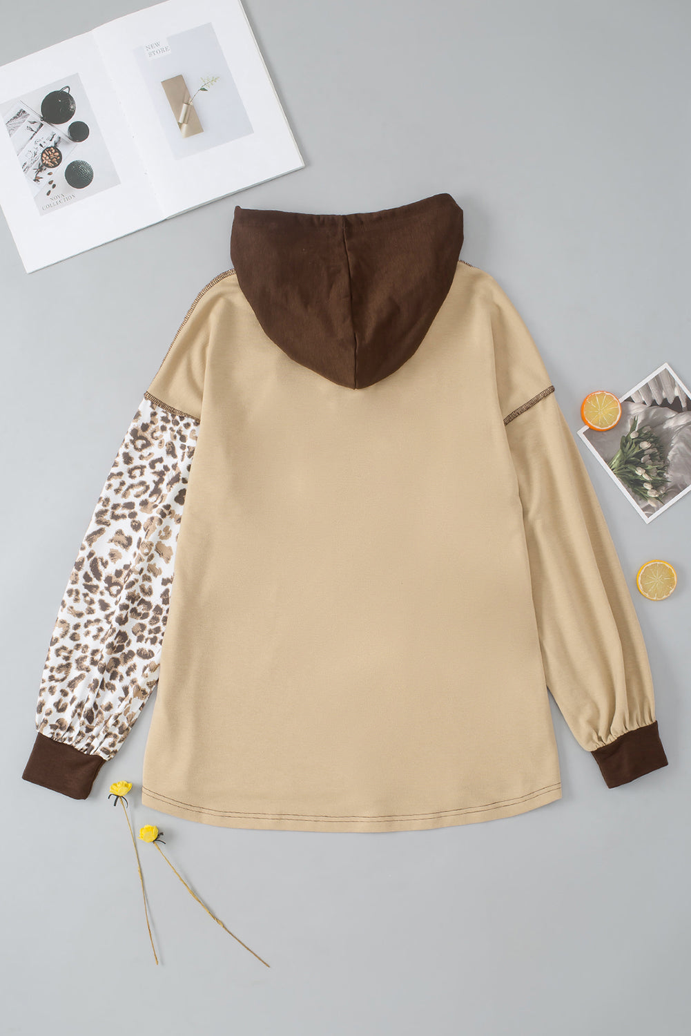 Leopard print drawstring hoodie with a chest pocket and buttons.