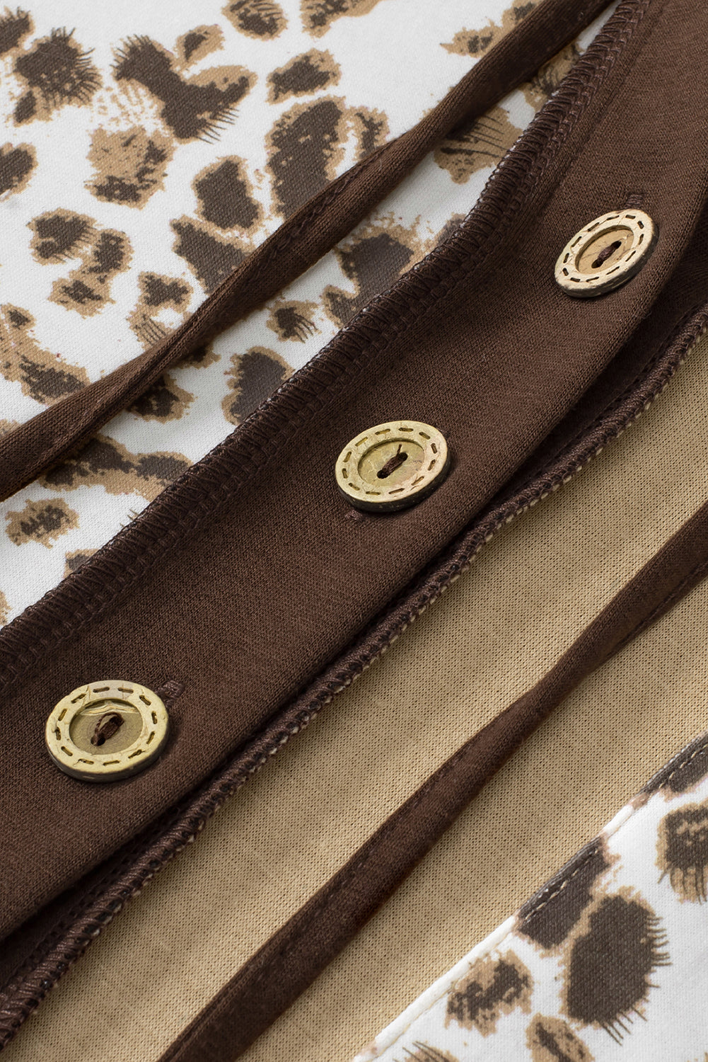 Leopard print drawstring hoodie with a chest pocket and buttons.