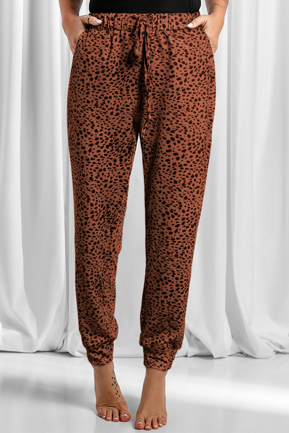 Leopard drawstring pocketed pants, opaque.