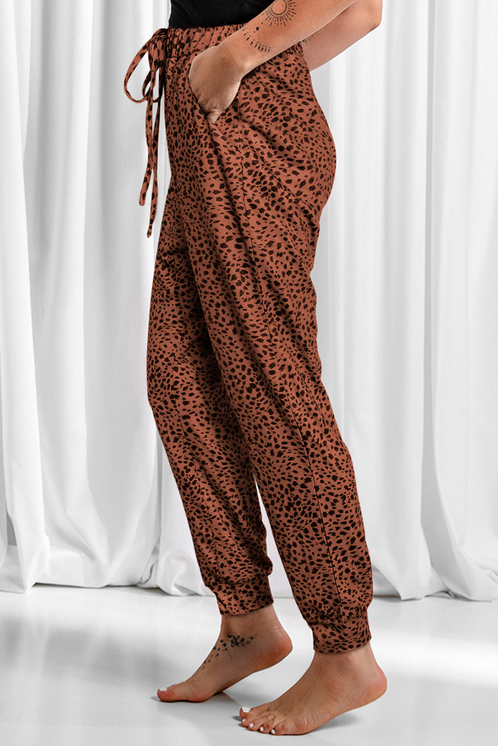 Leopard drawstring pocketed pants, opaque.
