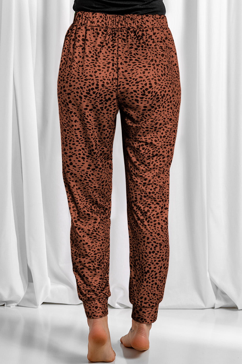 Leopard drawstring pocketed pants, opaque.