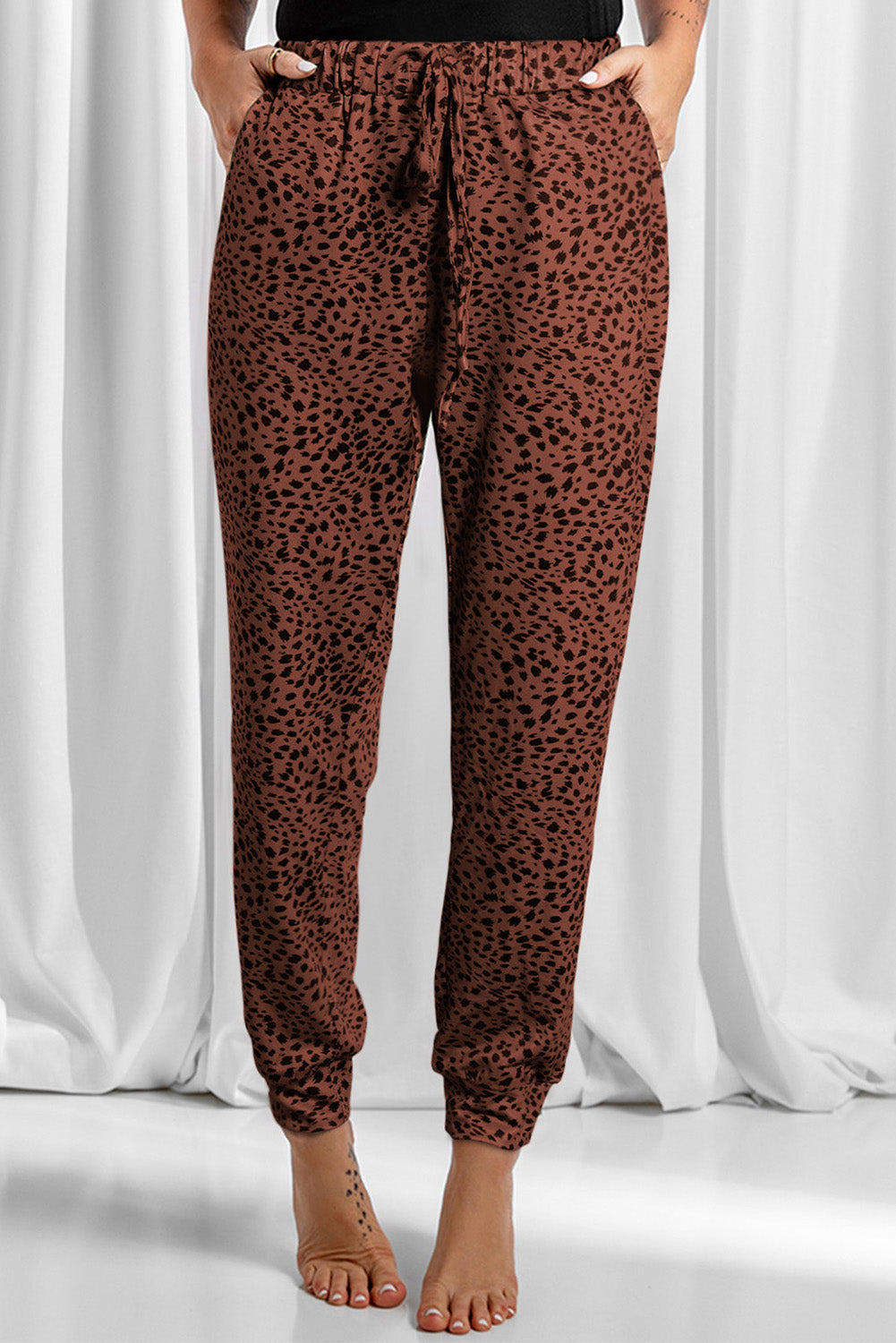 Leopard drawstring pocketed pants, opaque.
