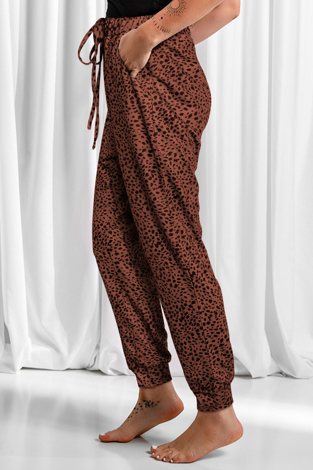 Leopard drawstring pocketed pants, opaque.
