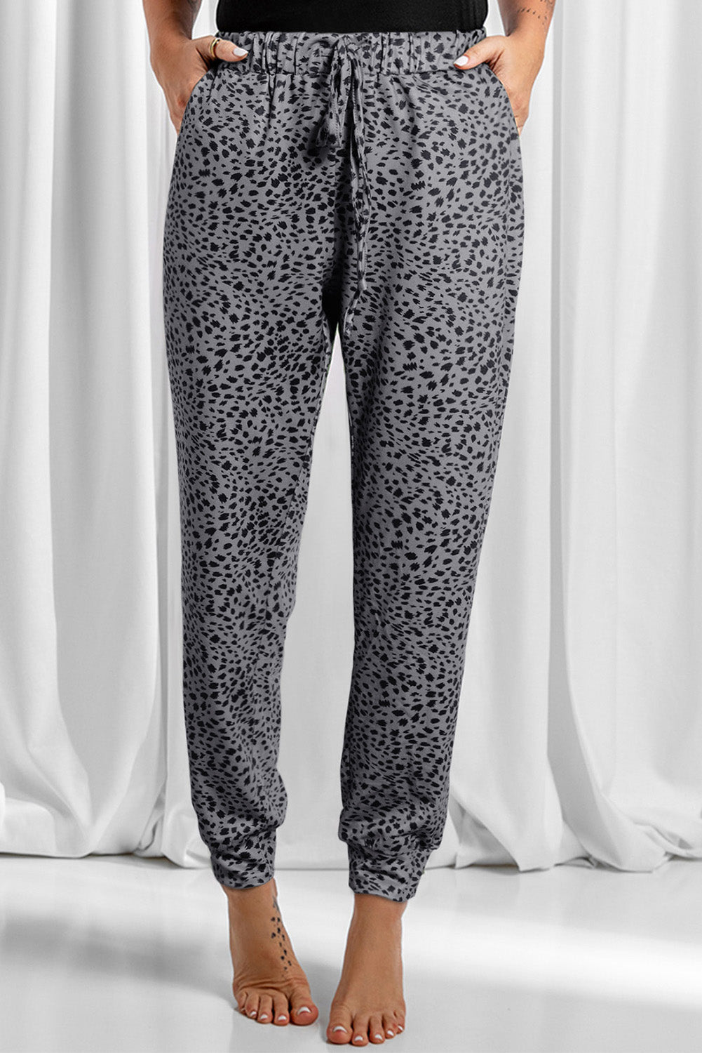 Leopard drawstring pocketed pants, opaque.