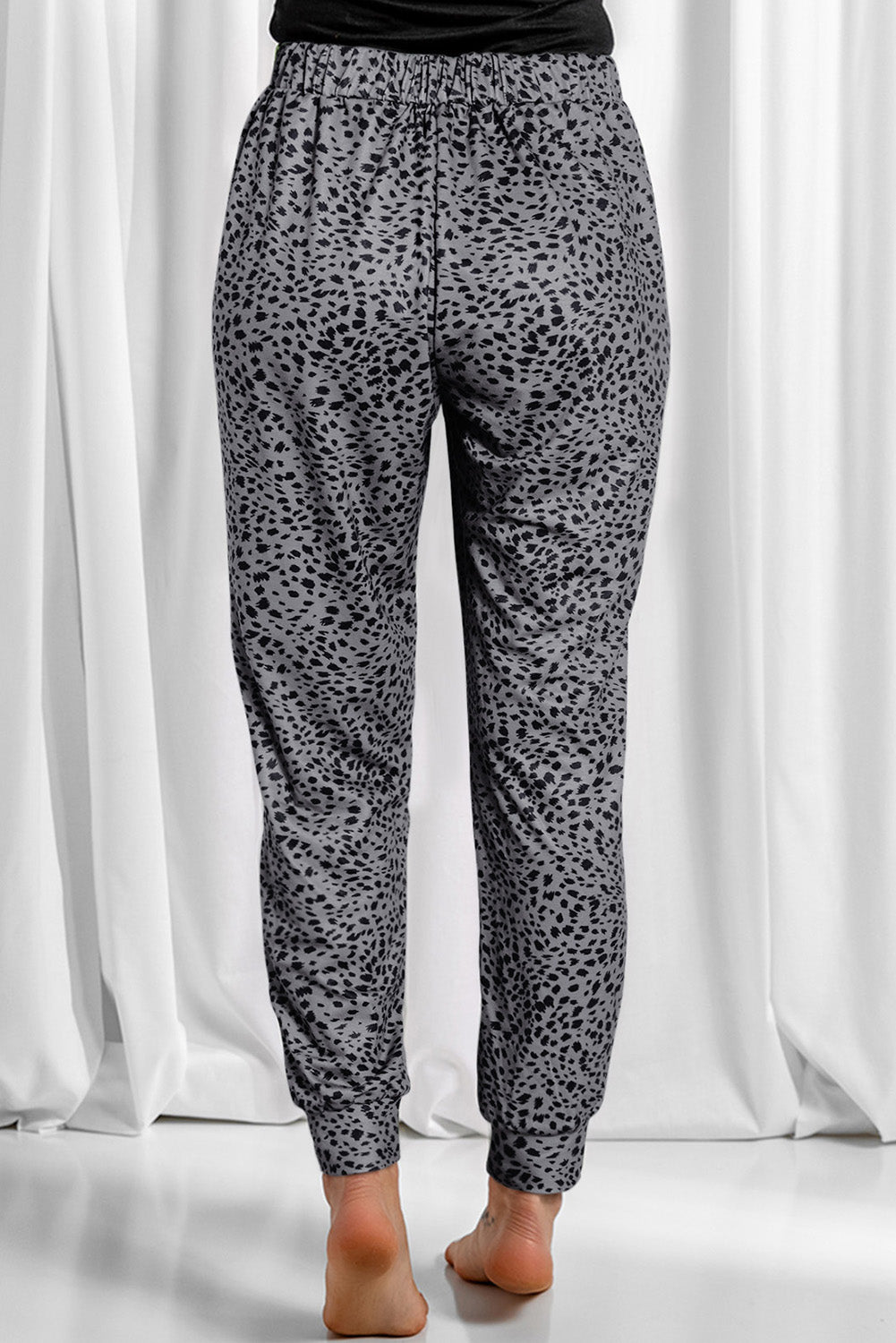 Leopard drawstring pocketed pants, opaque.