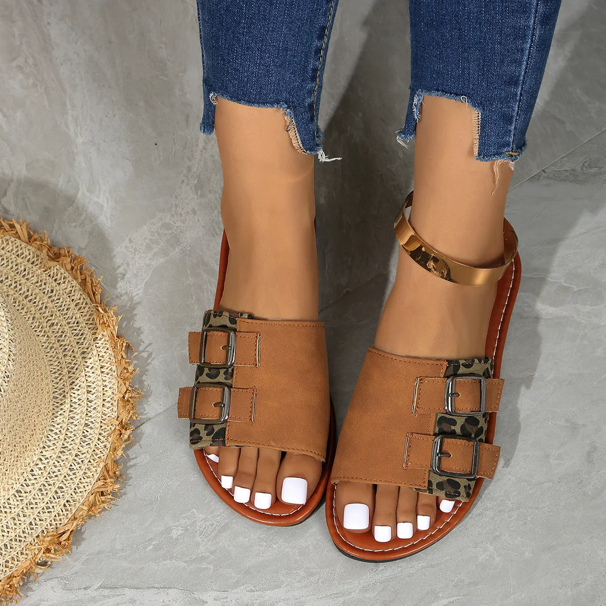 Leopard print open toe flat sandals.