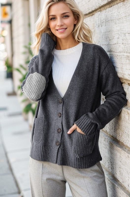 Full size long sleeve V-neck button down cardigan with pockets and ribbed details.