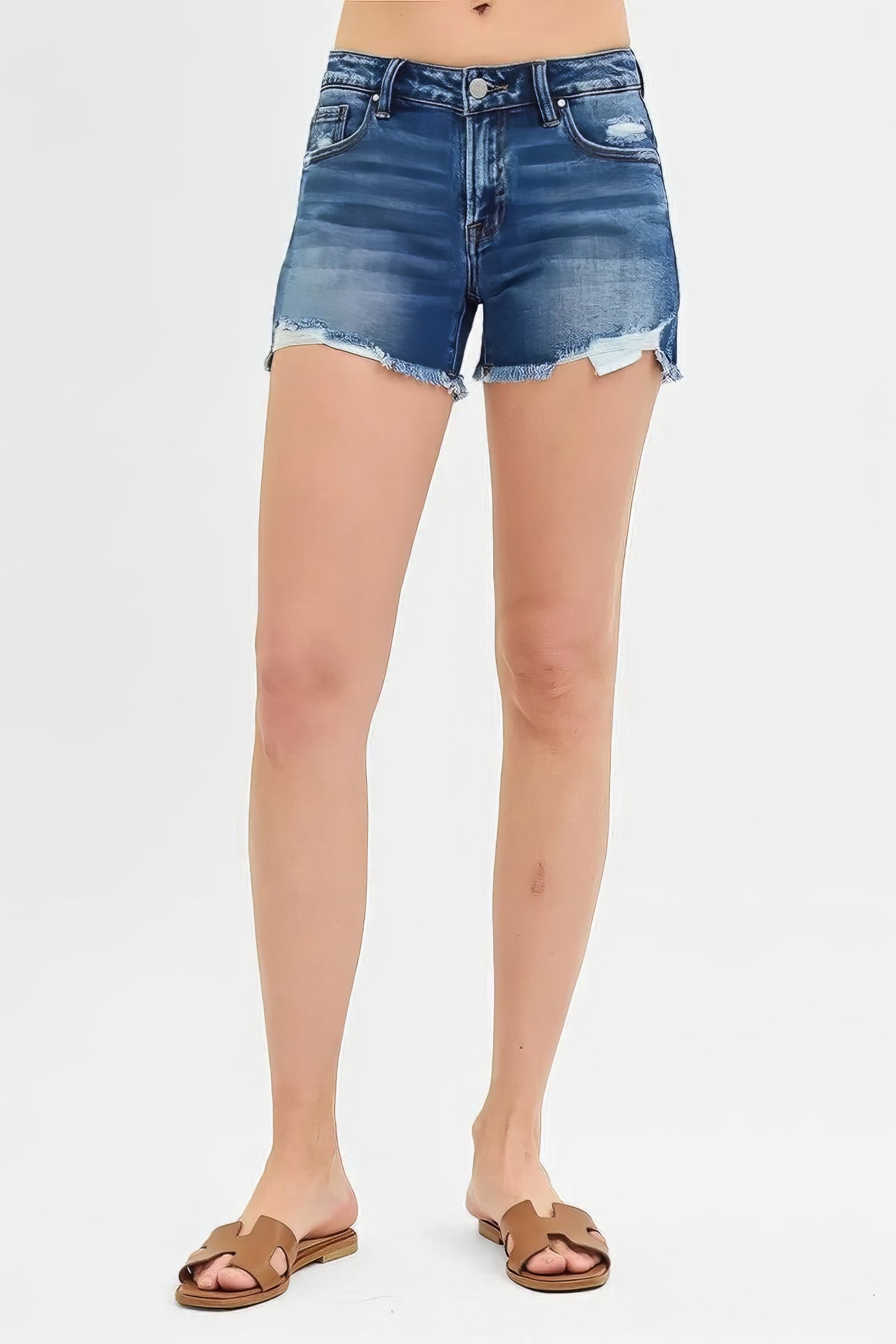 Low rise distressed denim shorts with raw hem and cat's whisker detail.