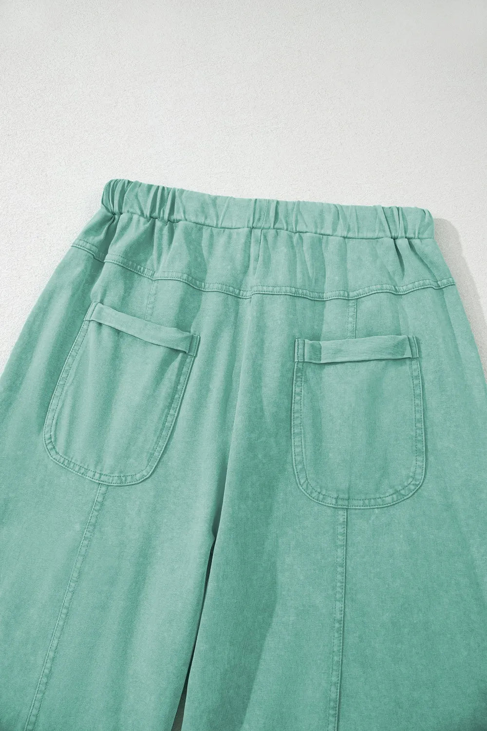 Mineral wash exposed seam drawstring high waist wide leg cargo pants with pockets.