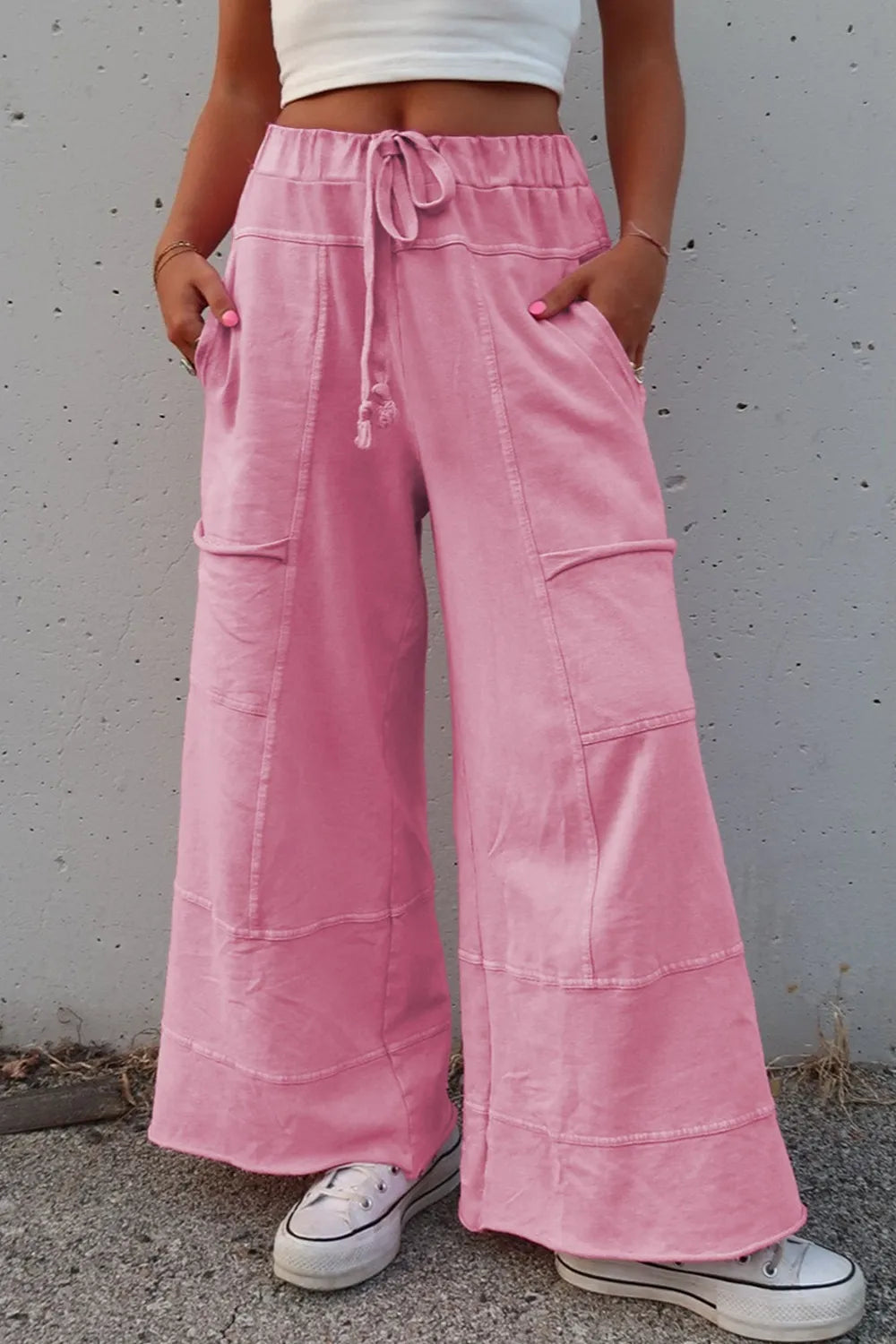 Mineral wash exposed seam drawstring high waist wide leg cargo pants with pockets.