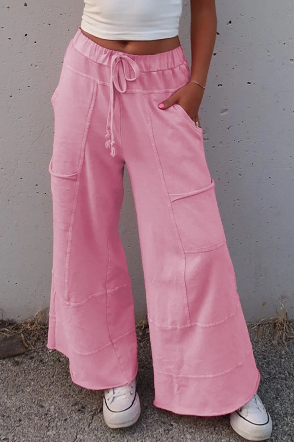 Mineral wash exposed seam drawstring high waist wide leg cargo pants with pockets.