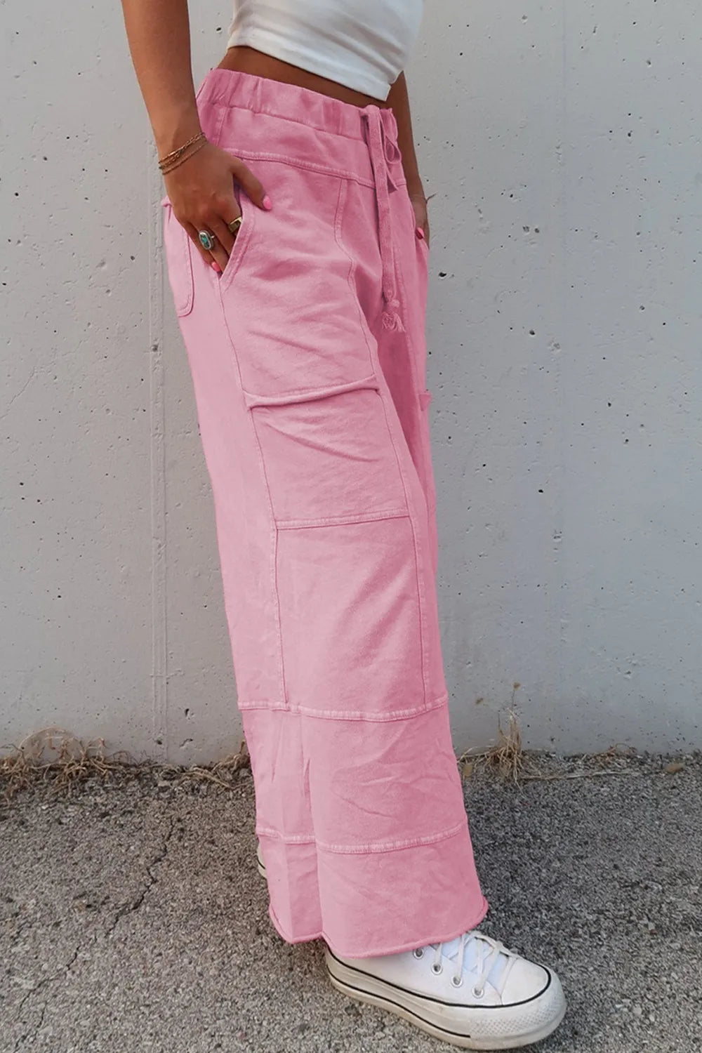 Mineral wash exposed seam drawstring high waist wide leg cargo pants with pockets.