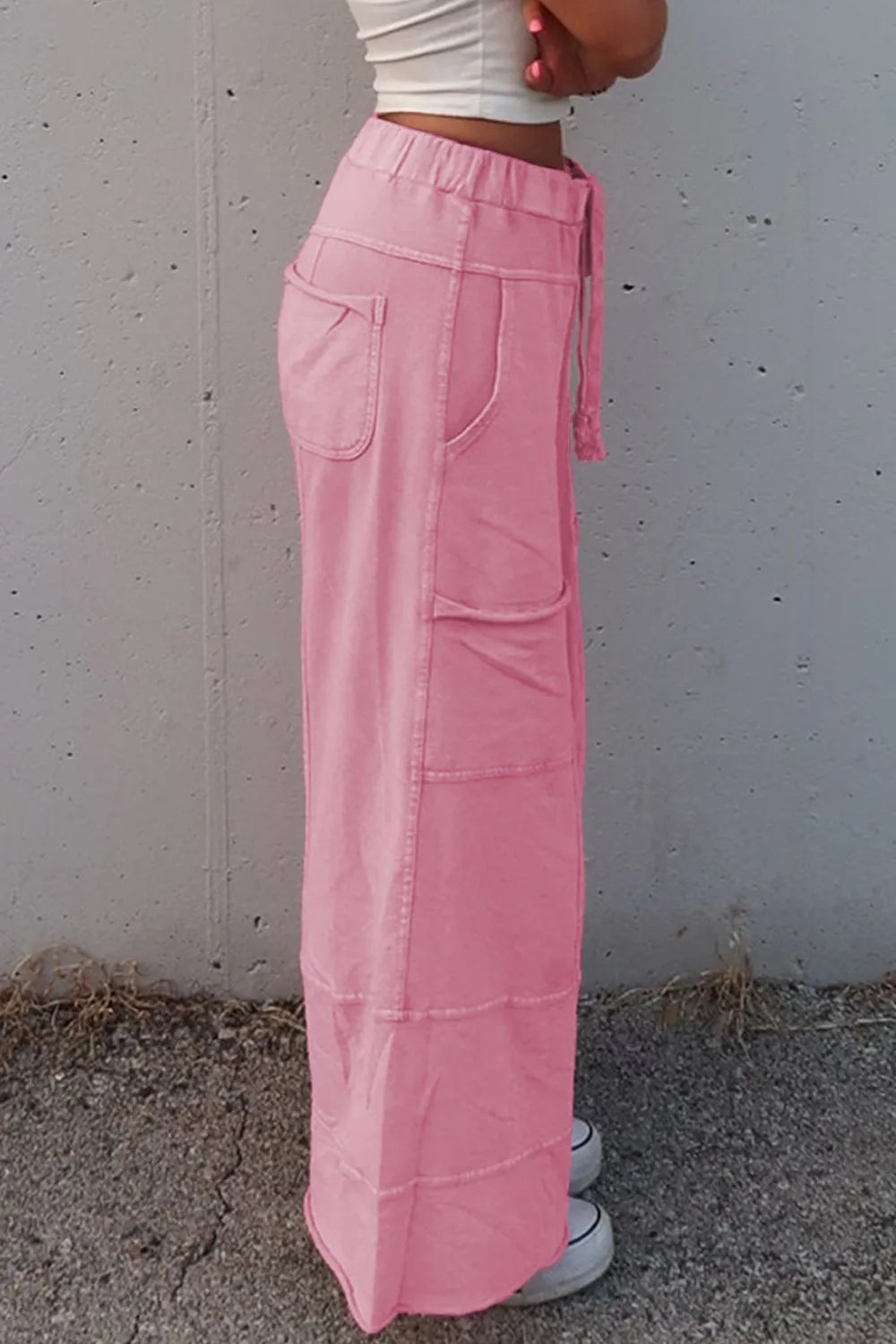 Mineral wash exposed seam drawstring high waist wide leg cargo pants with pockets.