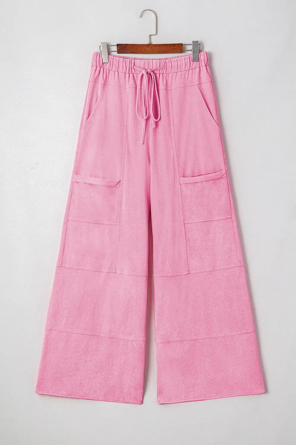 Mineral wash exposed seam drawstring high waist wide leg cargo pants with pockets.