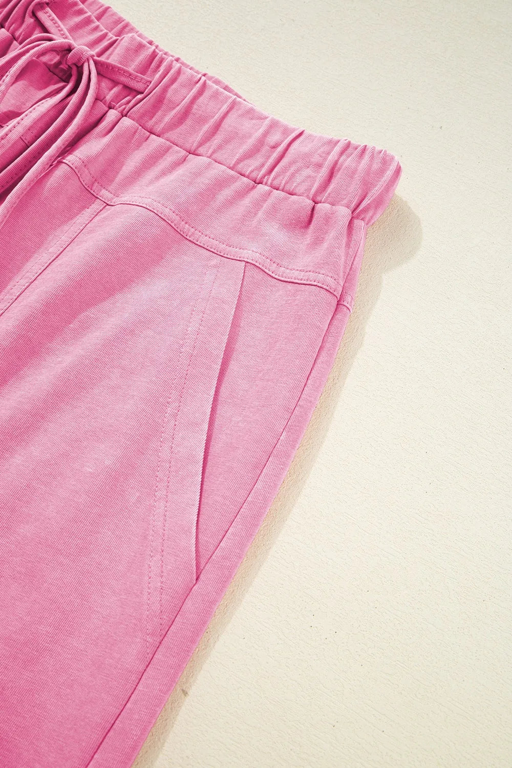 Mineral wash exposed seam drawstring high waist wide leg cargo pants with pockets.