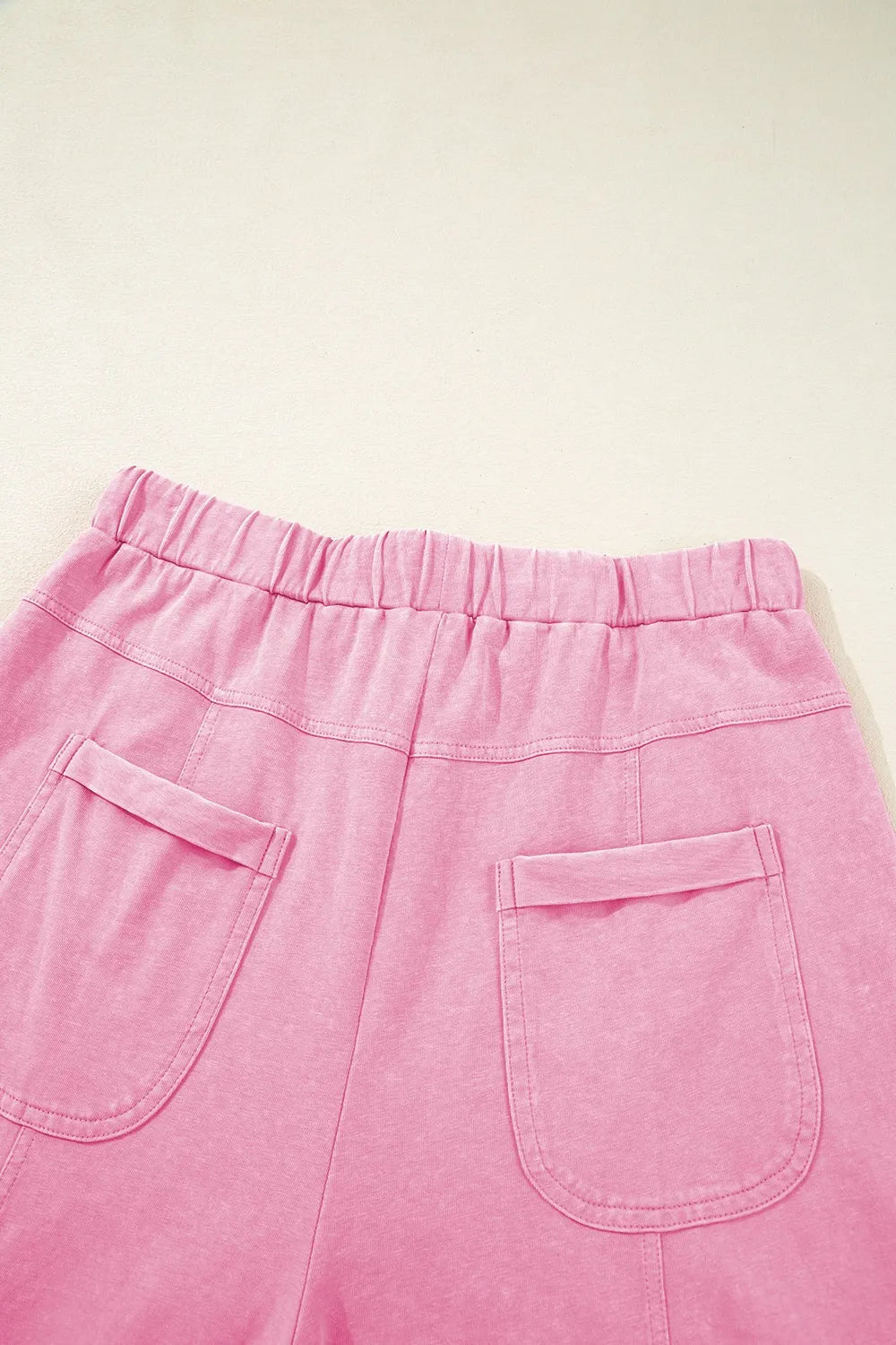 Mineral wash exposed seam drawstring high waist wide leg cargo pants with pockets.