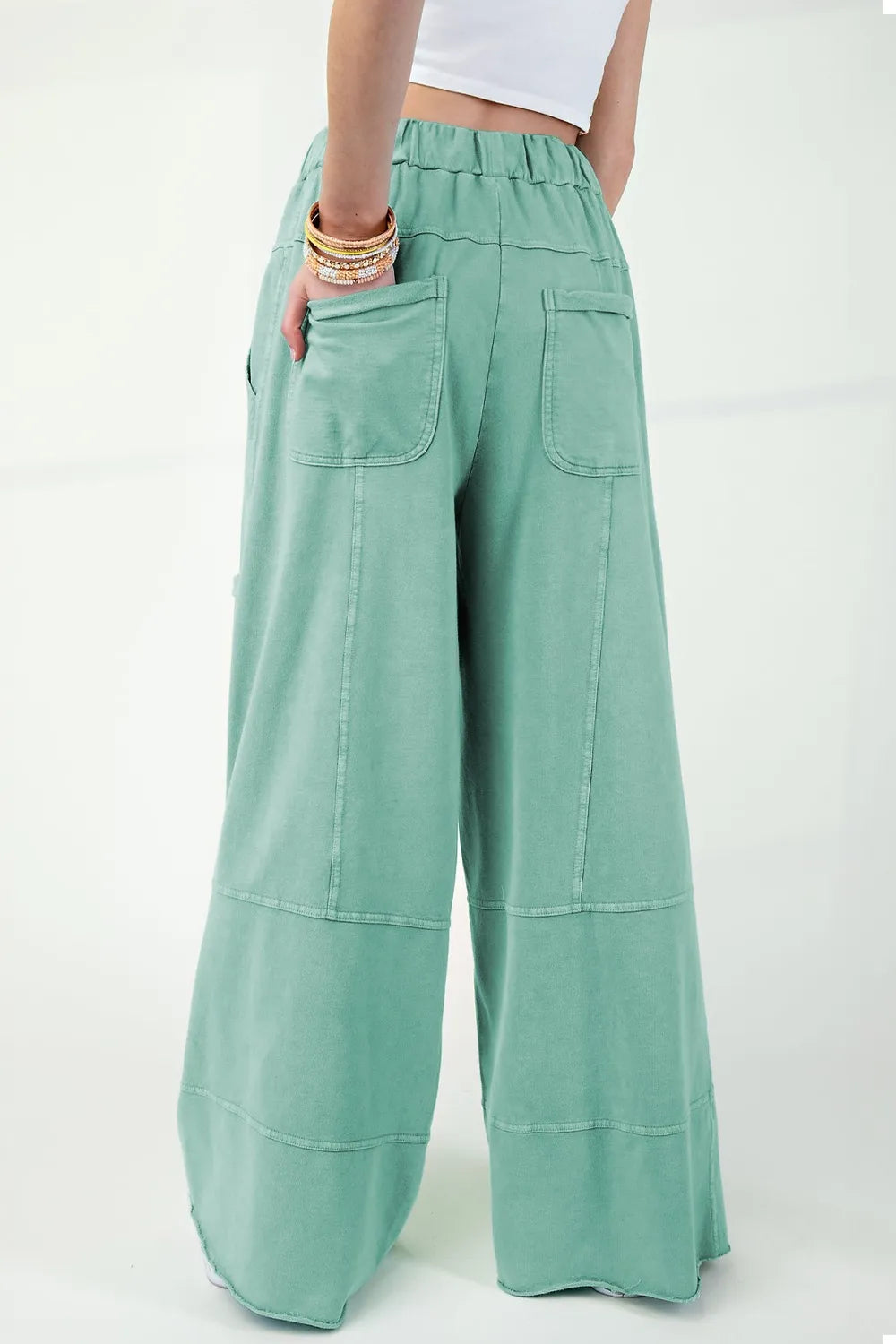 Mineral wash exposed seam drawstring high waist wide leg cargo pants with pockets.