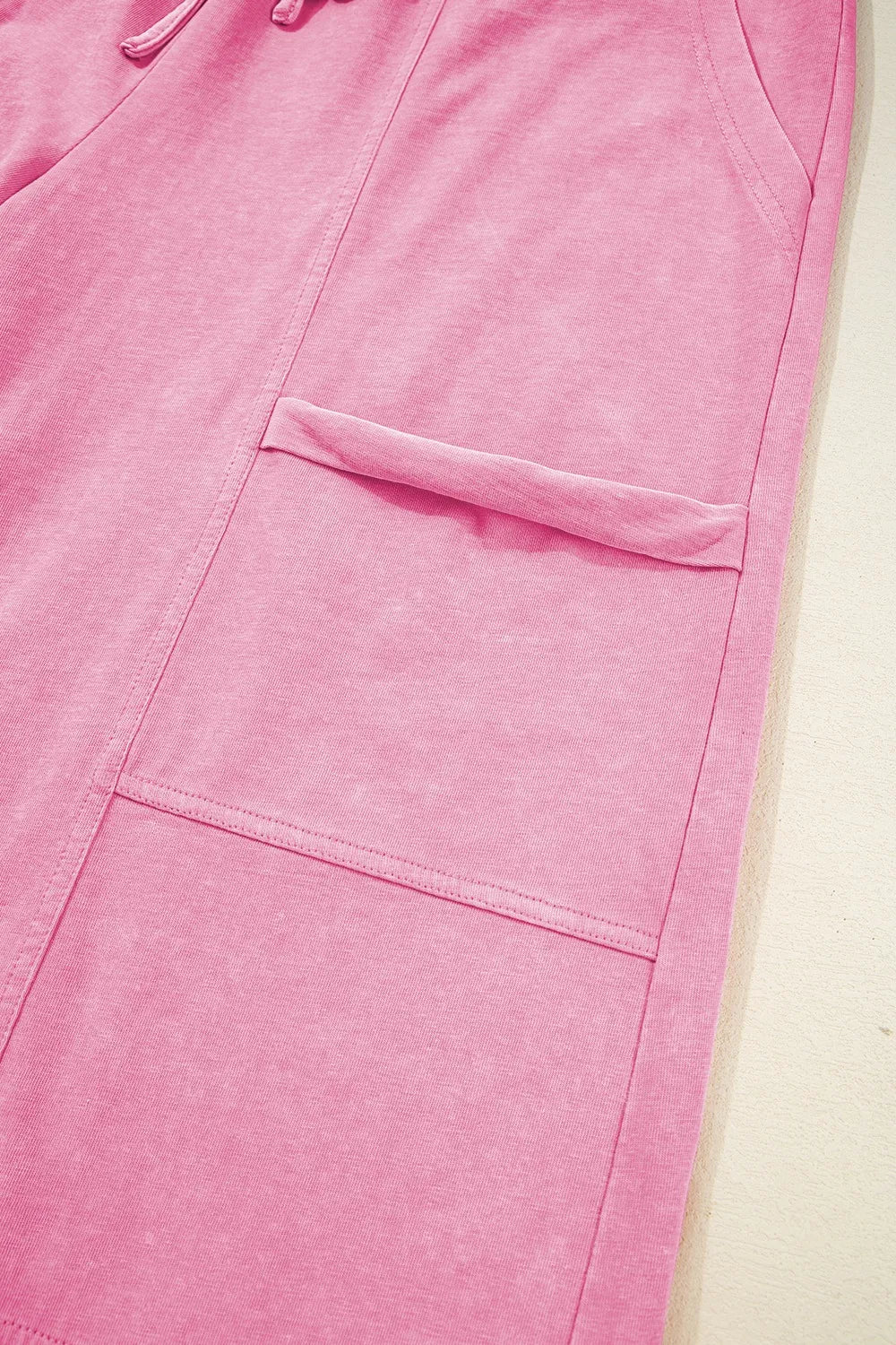 Mineral wash exposed seam drawstring high waist wide leg cargo pants with pockets.