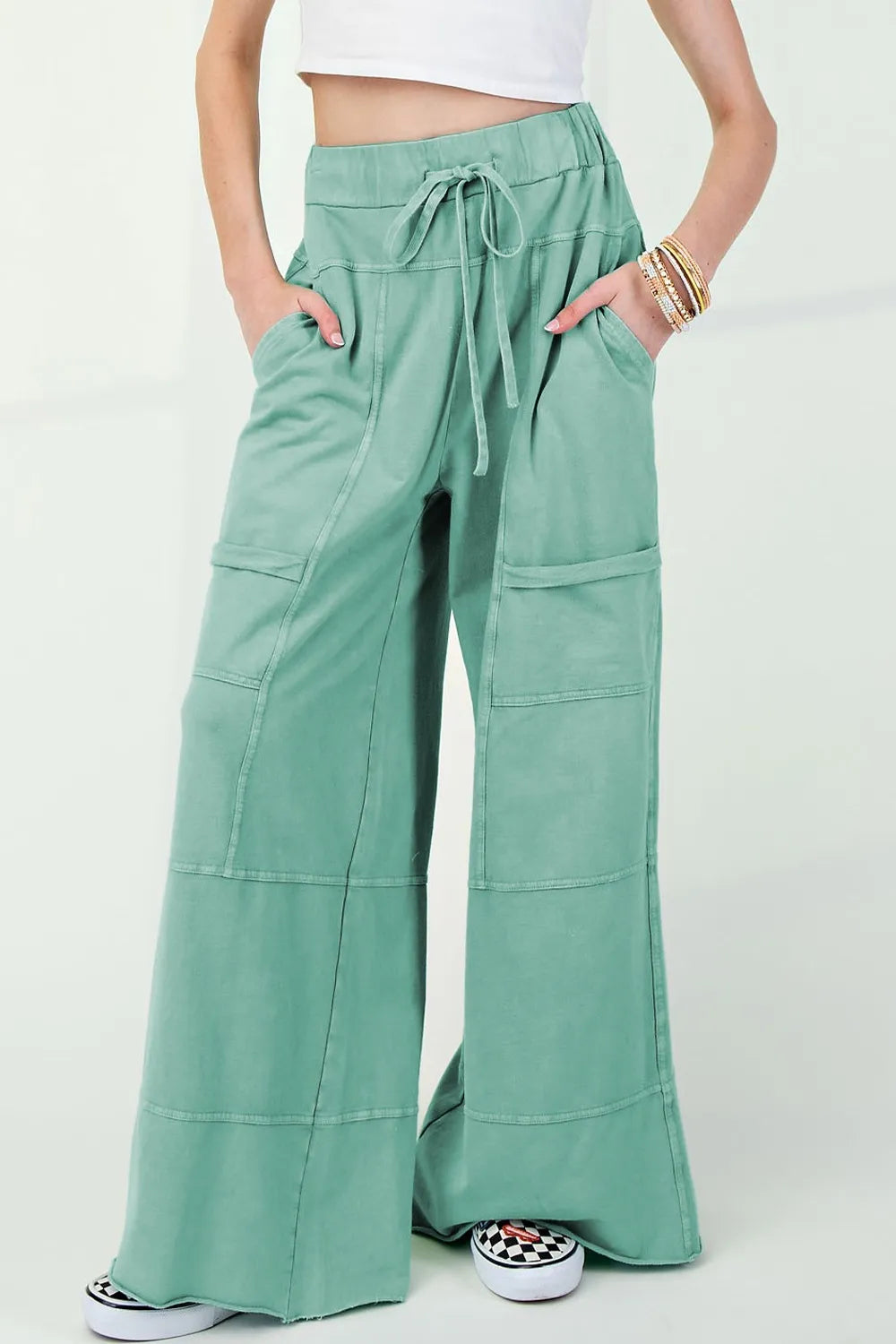 Mineral wash exposed seam drawstring high waist wide leg cargo pants with pockets.