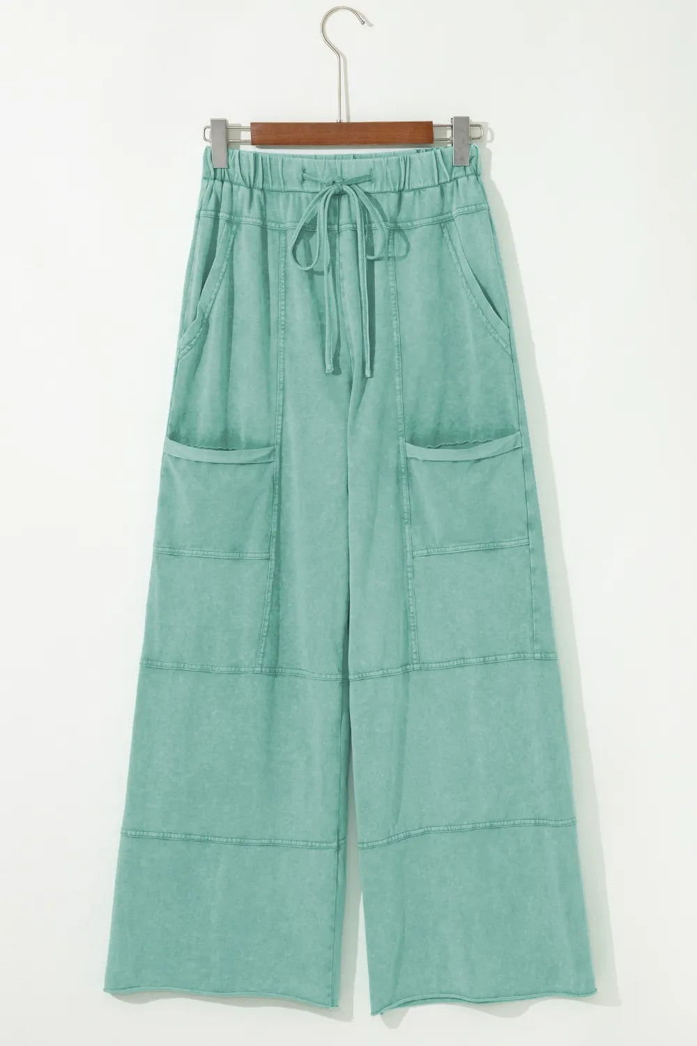 Mineral wash exposed seam drawstring high waist wide leg cargo pants with pockets.