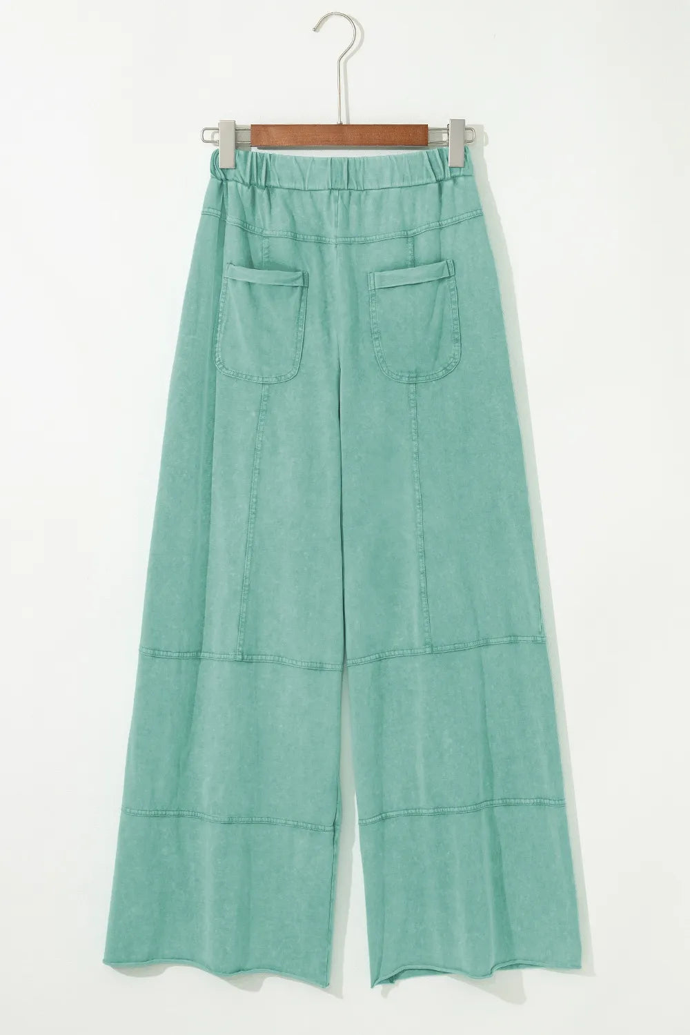Mineral wash exposed seam drawstring high waist wide leg cargo pants with pockets.