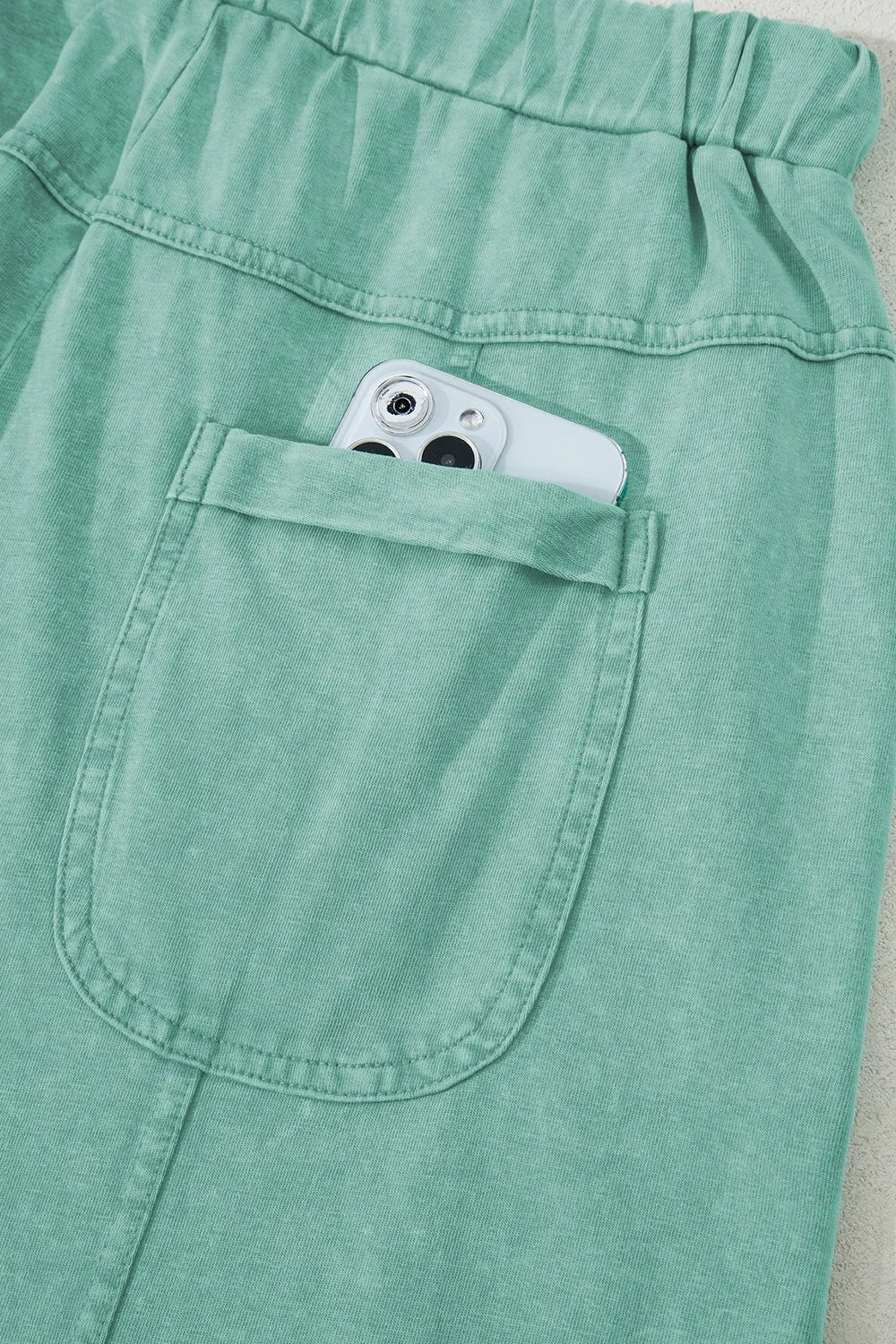 Mineral wash exposed seam drawstring high waist wide leg cargo pants with pockets.