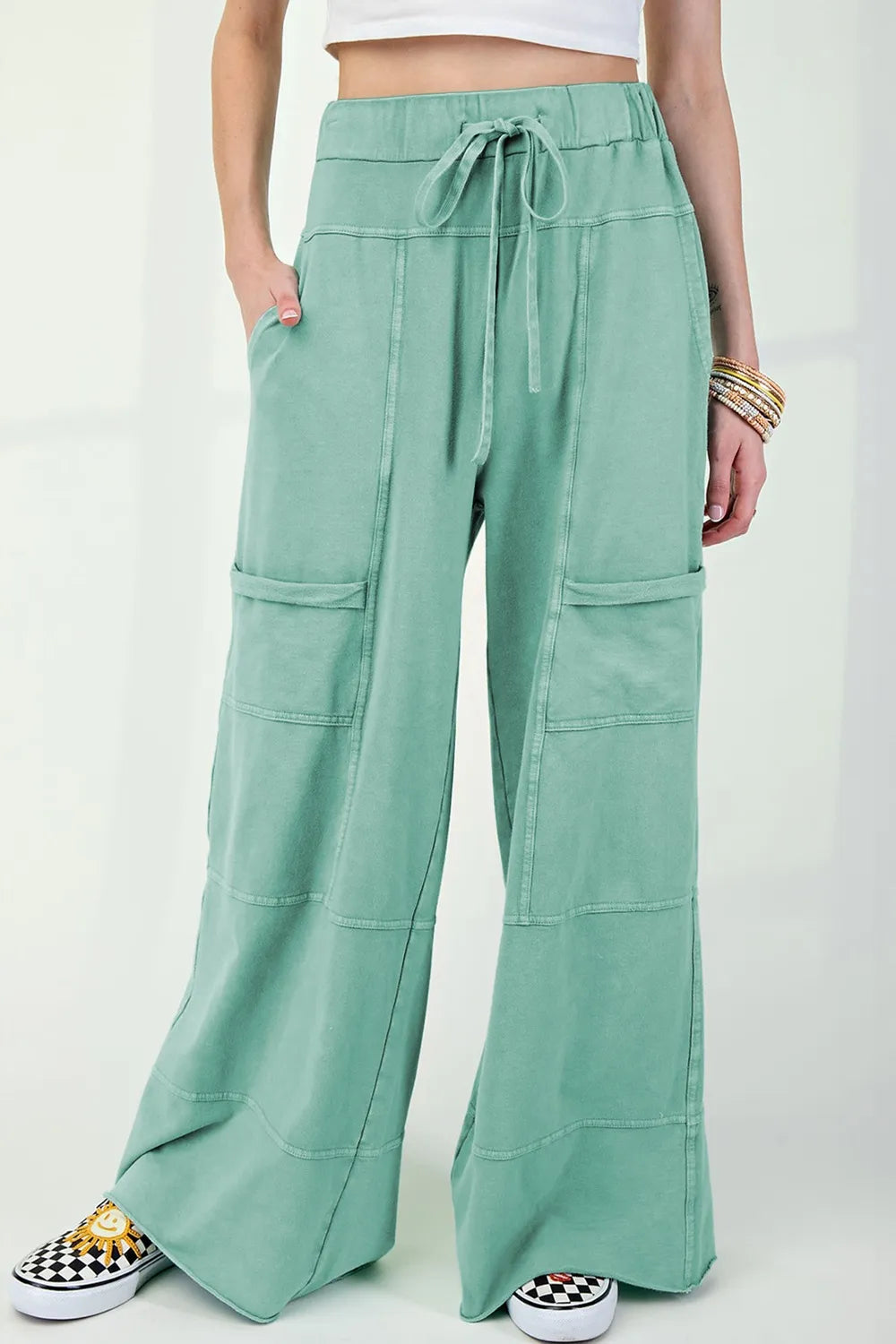 Mineral wash exposed seam drawstring high waist wide leg cargo pants with pockets.
