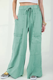 Mineral wash exposed seam drawstring high waist wide leg cargo pants with pockets.