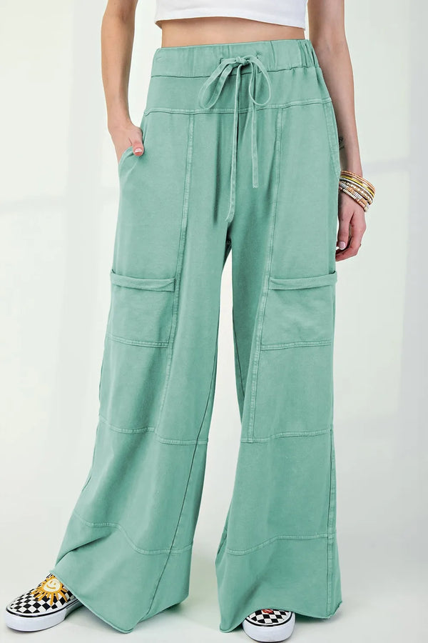 Mineral wash exposed seam drawstring high waist wide leg cargo pants with pockets.
