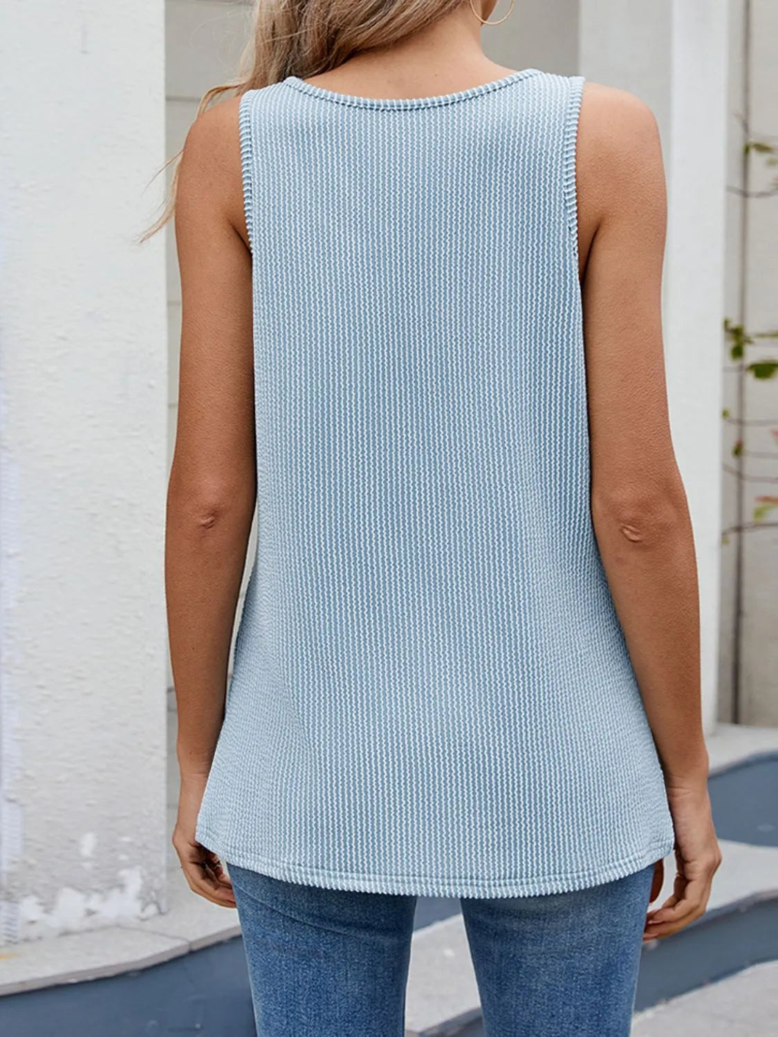 O-ring cutout ribbed knit tank top with crisscross detail.