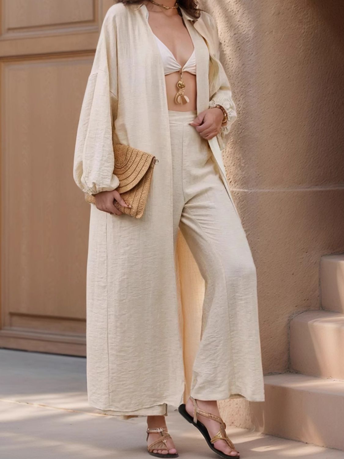 Two-piece set: open front balloon sleeve cardigan and matching pants.