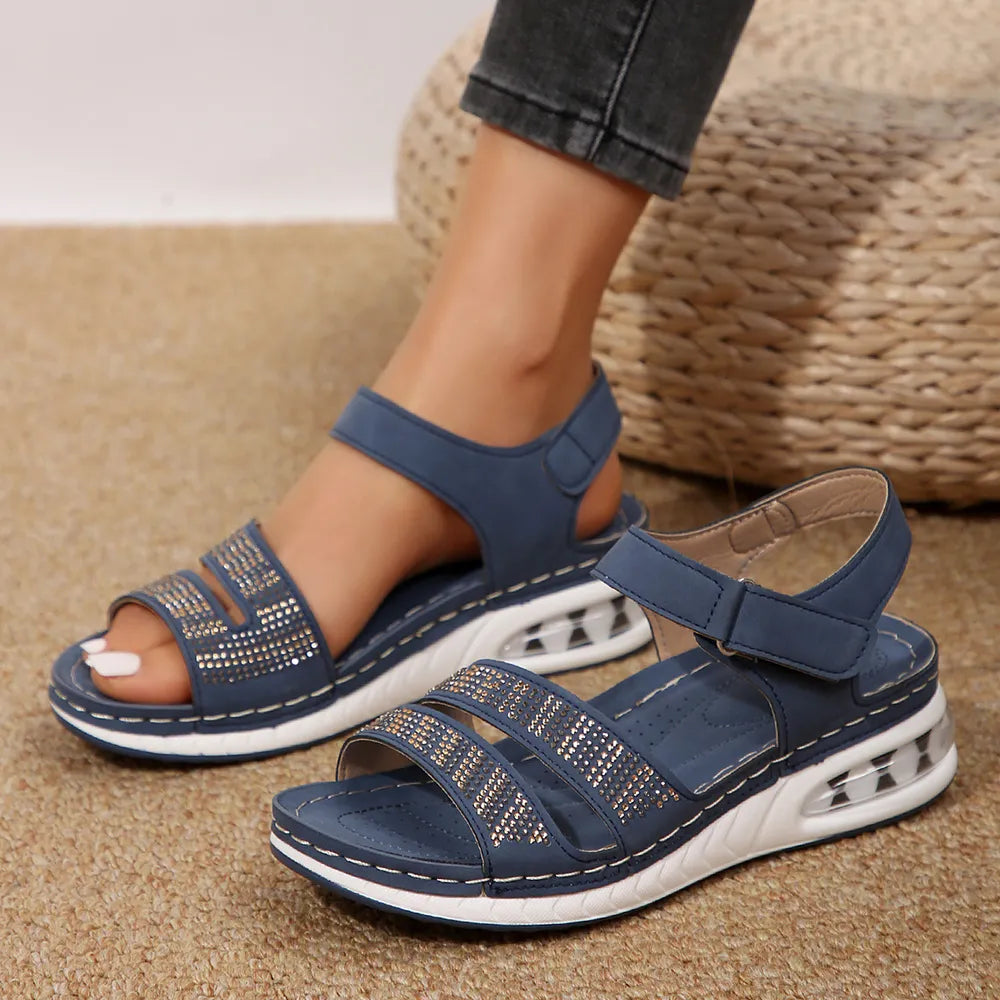 Open toe inlaid rhinestone low heel wedge sandals.