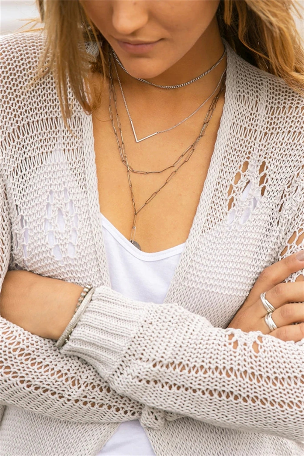 Openwork side slit open front long sleeve cardigan with cutout details.