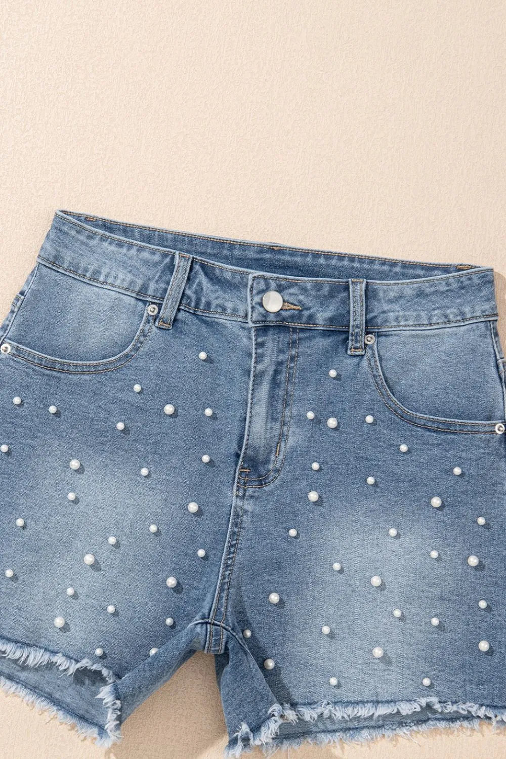 High-waist washed denim shorts with pockets.