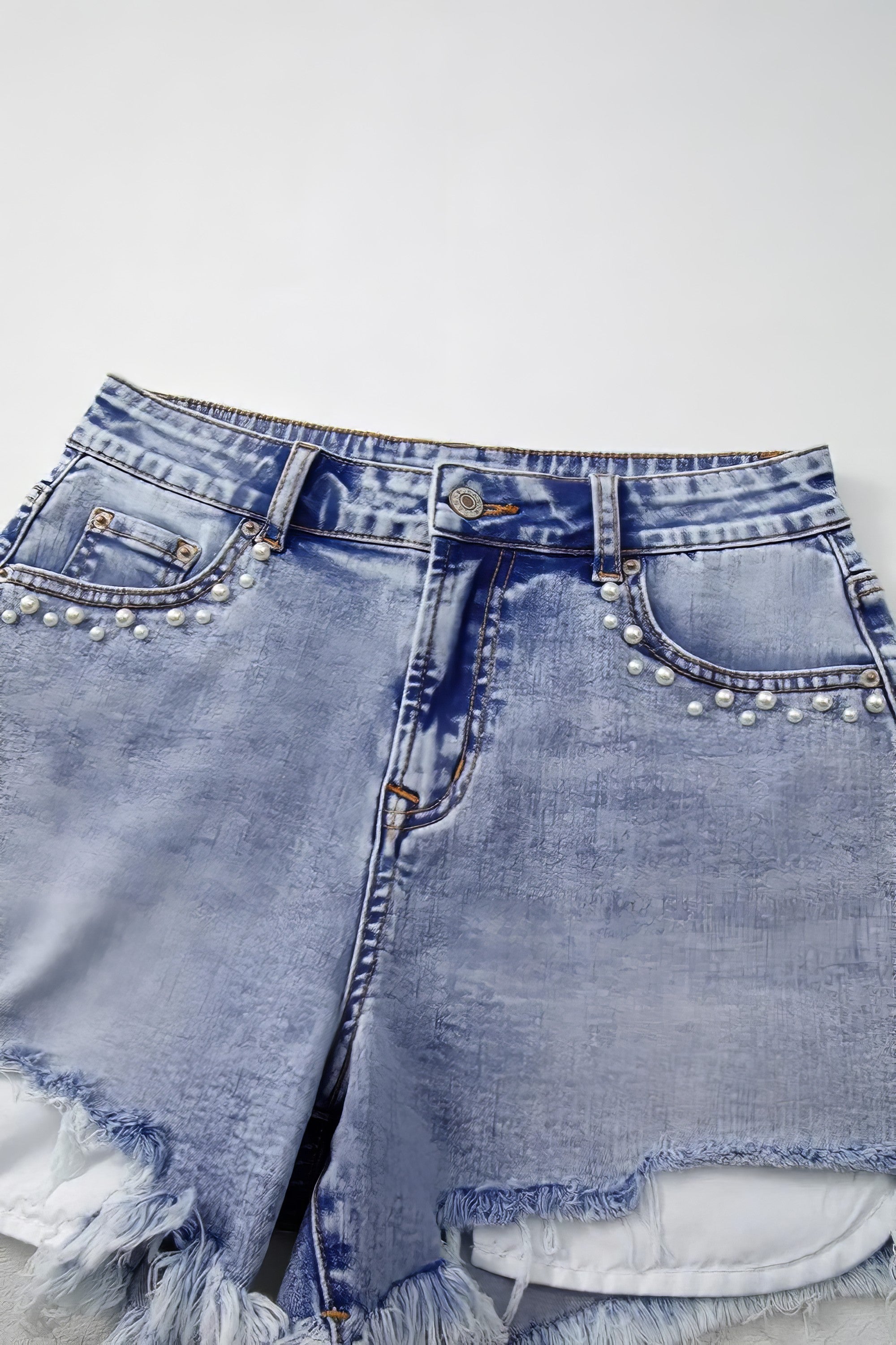 Pearl studded pockets raw hem denim shorts.