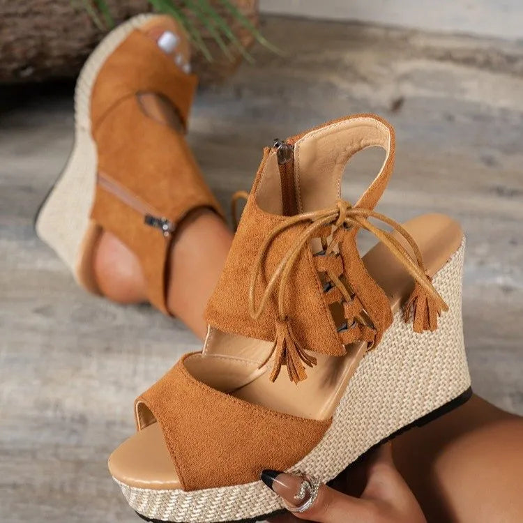 Suede peep toe mid-heel wedge sandals.