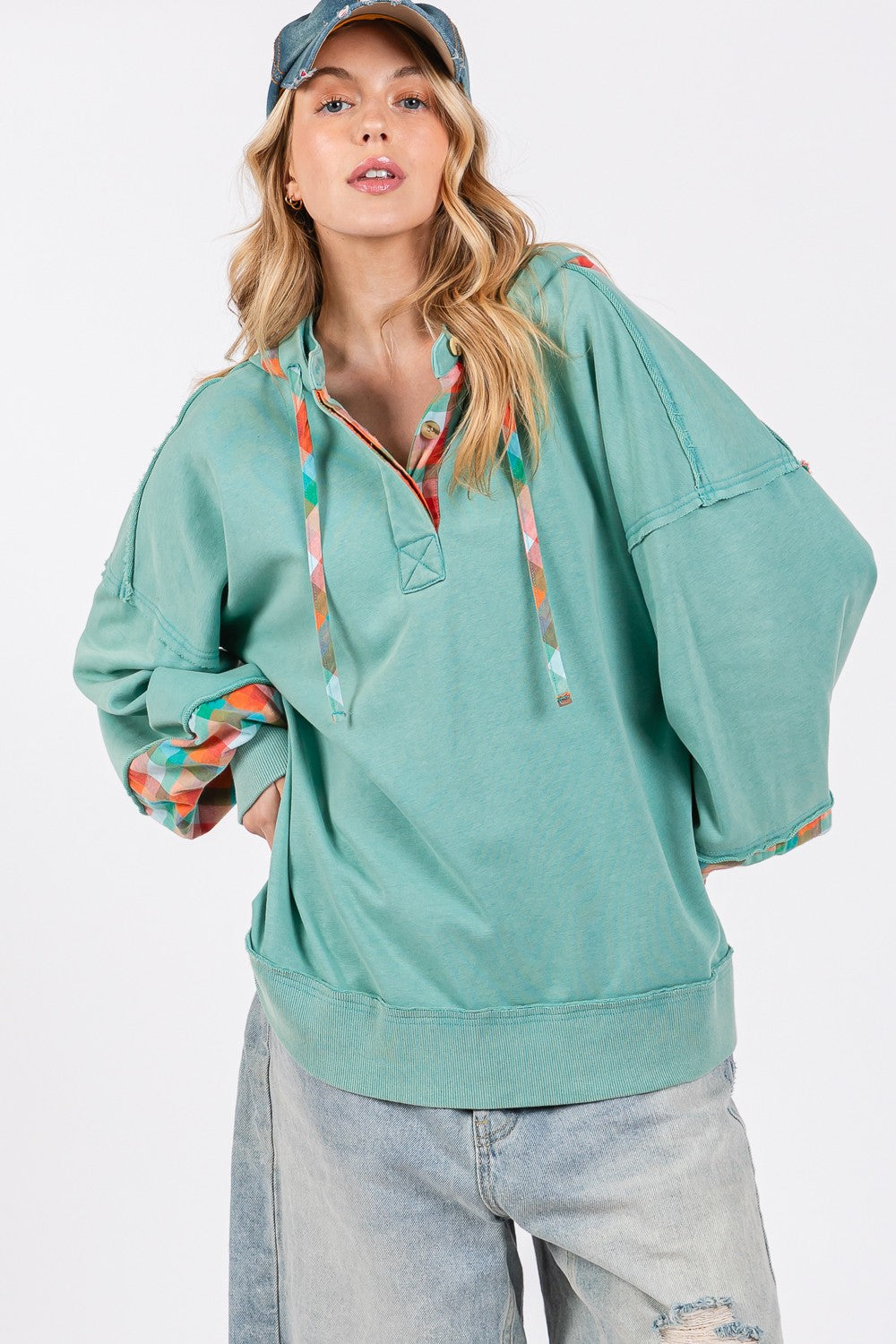 Full size plaid print washed hoodie with exposed seams, drawstring, and half buttons.