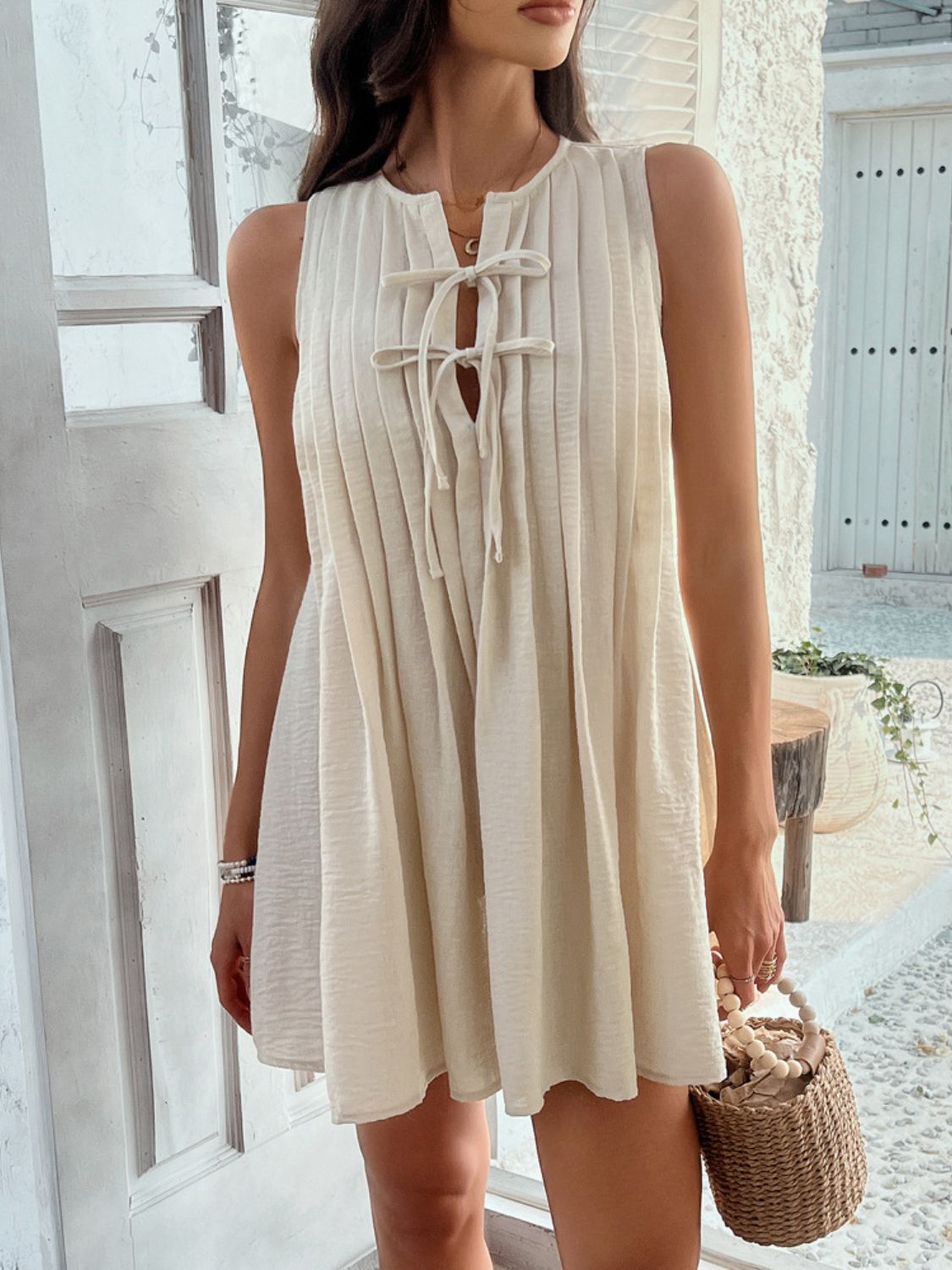 Devine Pleated Sleeveless Mini Dress.
