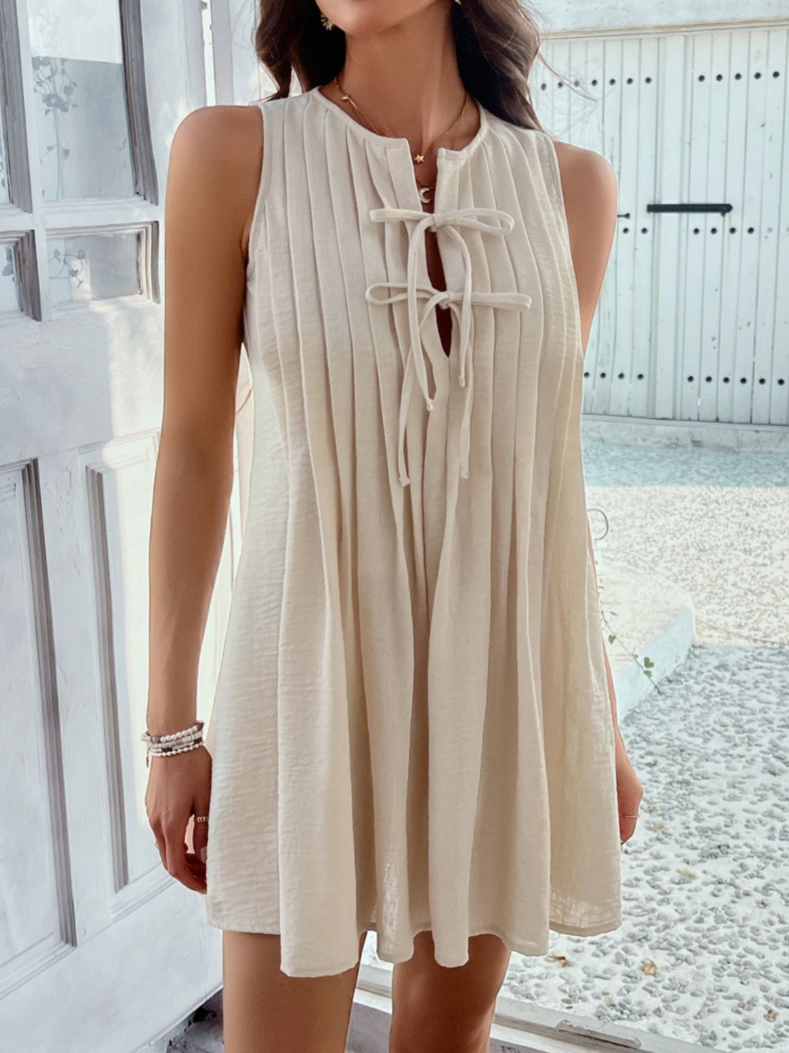 Devine Pleated Sleeveless Mini Dress.