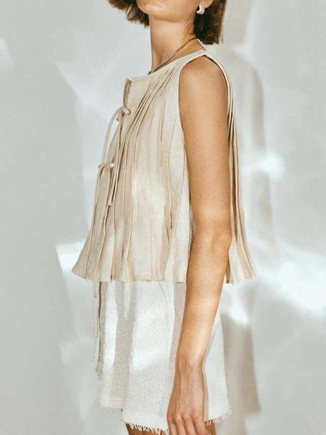 Pleated tied round neck vest.