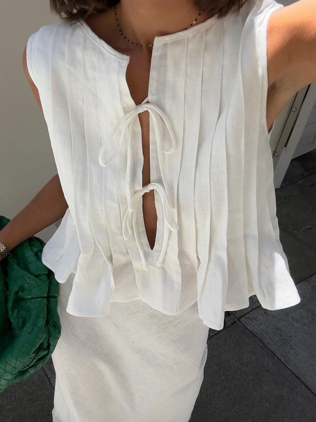 Pleated tied round neck vest.