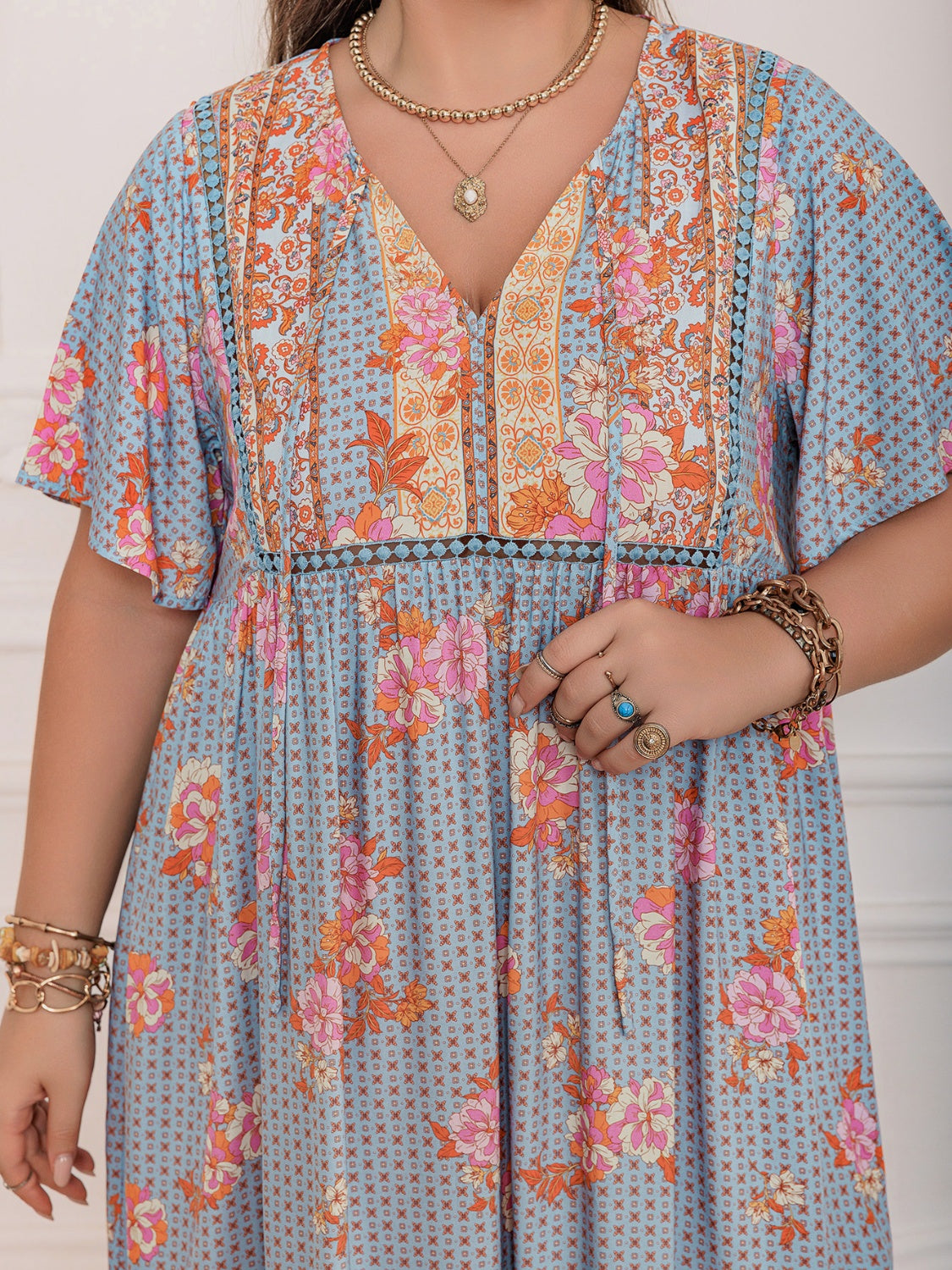Plus Size Printed Tie Neck Flutter Sleeve Maxi Dress.