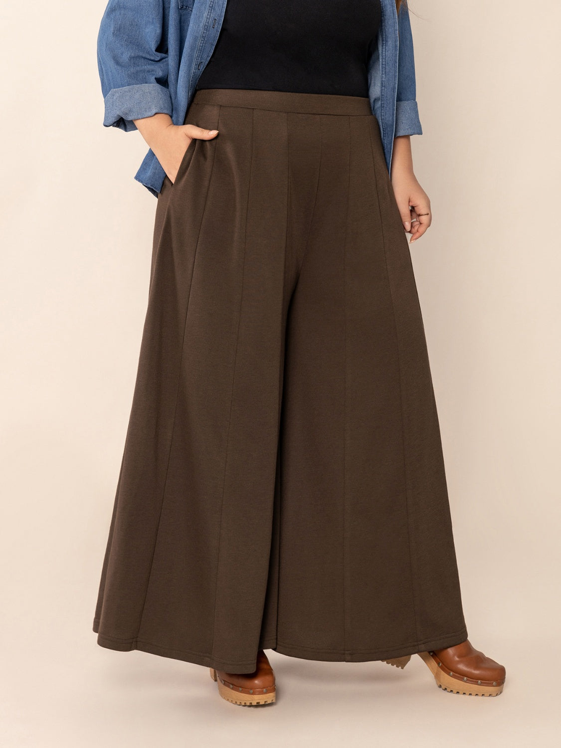 Plus size wide leg pants with pockets and ruched detail, opaque.